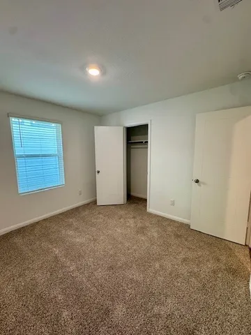 a view of kitchen with stainless steel appliances cabinets and wooden floor