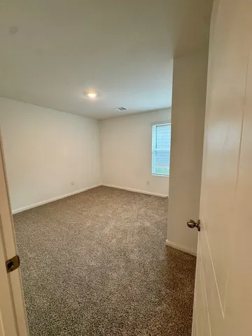 a view of an empty room and a window