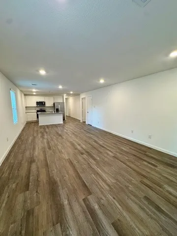 a view of an empty room and wooden floor