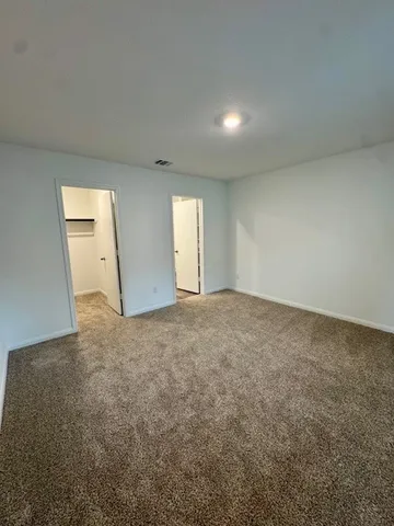 a bathroom with a granite countertop sink a toilet and shower