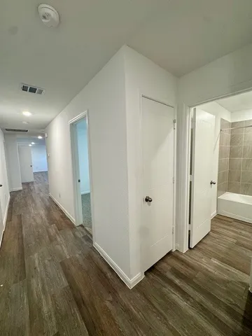 a bathroom with a granite countertop sink toilet a mirror and bathtub