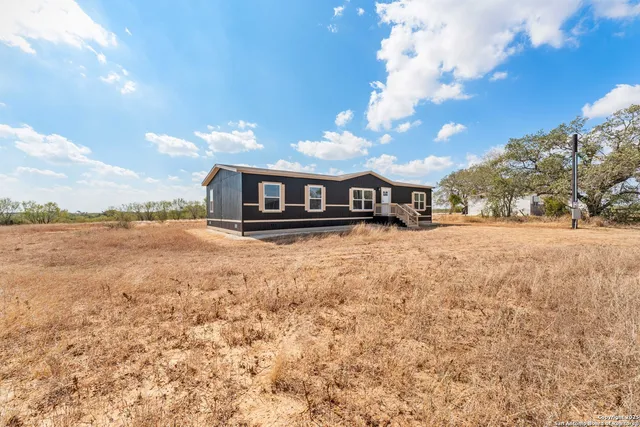 a view of house with yard and outdoor space