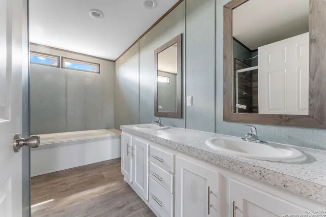 a kitchen with stainless steel appliances granite countertop a sink a stove a refrigerator a center island and cabinets