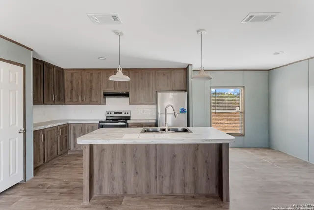 a view of a kitchen with furniture and a ceiling fan