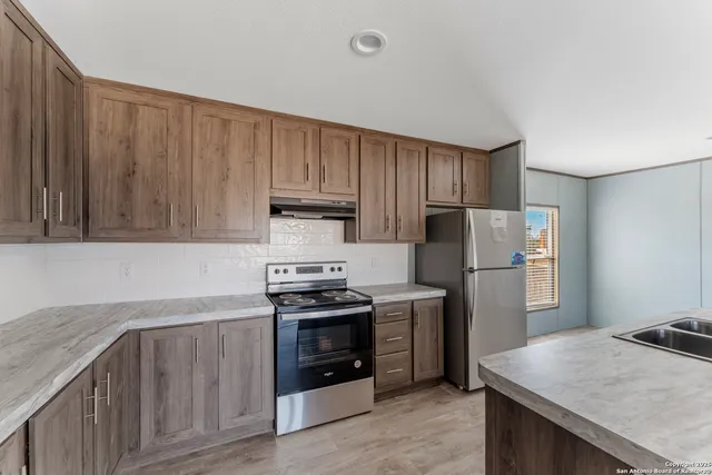 a bathroom with a granite countertop sink mirror and a bathtub