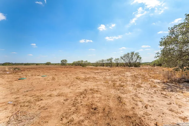 a kitchen with stainless steel appliances granite countertop a sink a stove a refrigerator a center island and cabinets