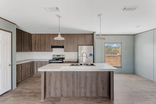 a view of a kitchen with furniture and a ceiling fan