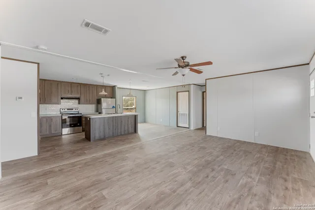 a kitchen with wooden cabinets and stainless steel appliances