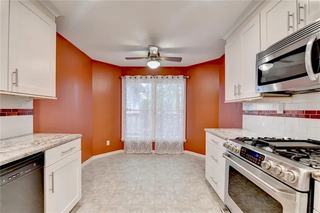 a kitchen with stainless steel appliances a stove a microwave and sink