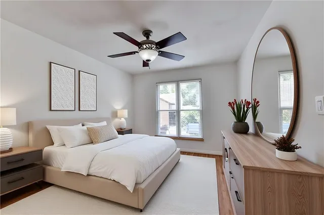 a bedroom with a large bed mirror and window