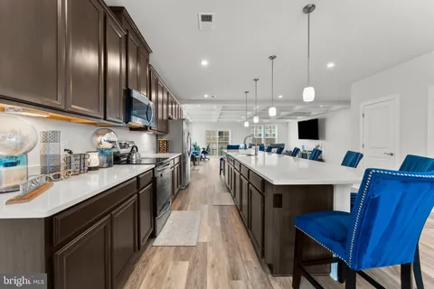 a kitchen with cabinets and wooden floor