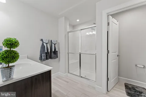 a hallway with a potted plant on table and chairs