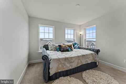 a bedroom with bed and window