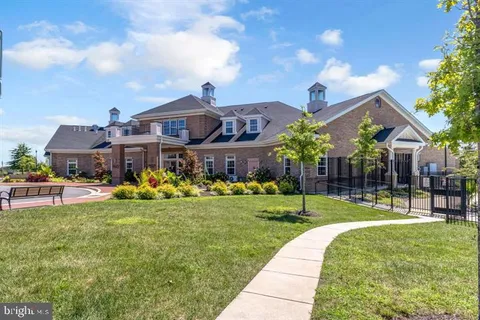 a front view of a house with a yard table and chairs