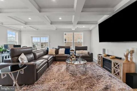 a living room with furniture wooden floor and a flat screen tv