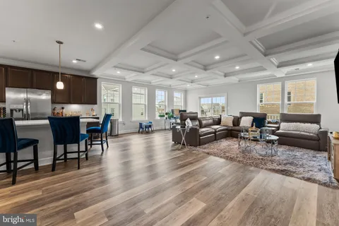 a living room with lots of furniture and kitchen view