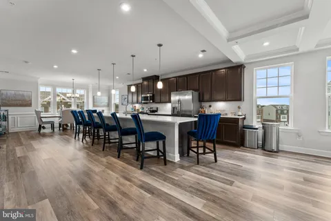 a kitchen with lots of wooden furniture appliances and cabinets