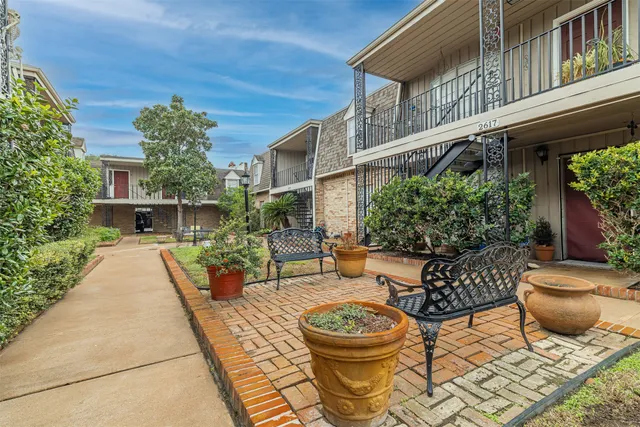 a view of a patio with couches table and chairs and potted plants