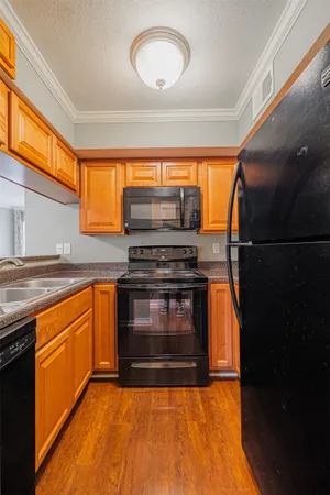 a kitchen with granite countertop a stove and a microwave