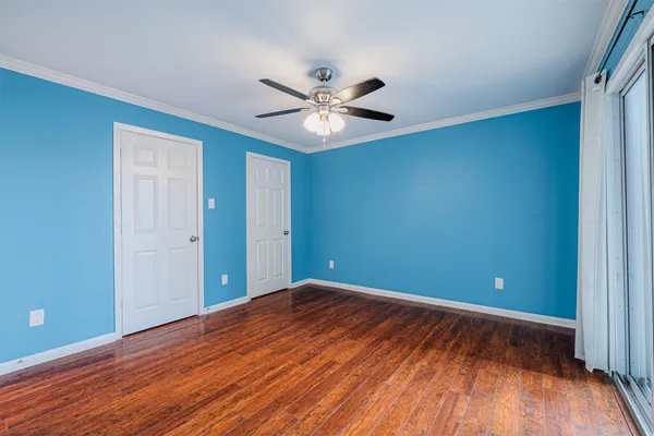 a view of an empty room with wooden floor