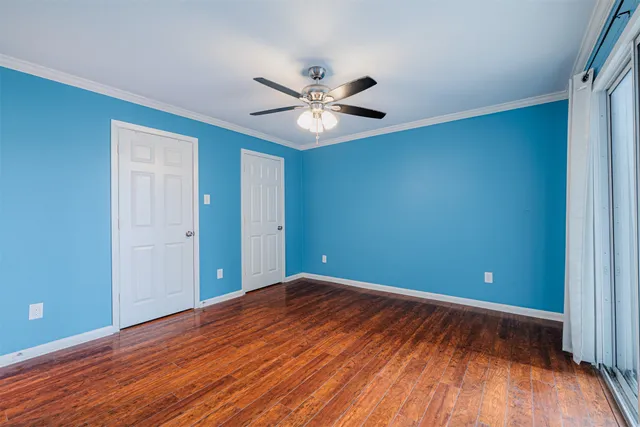 a view of an empty room with wooden floor