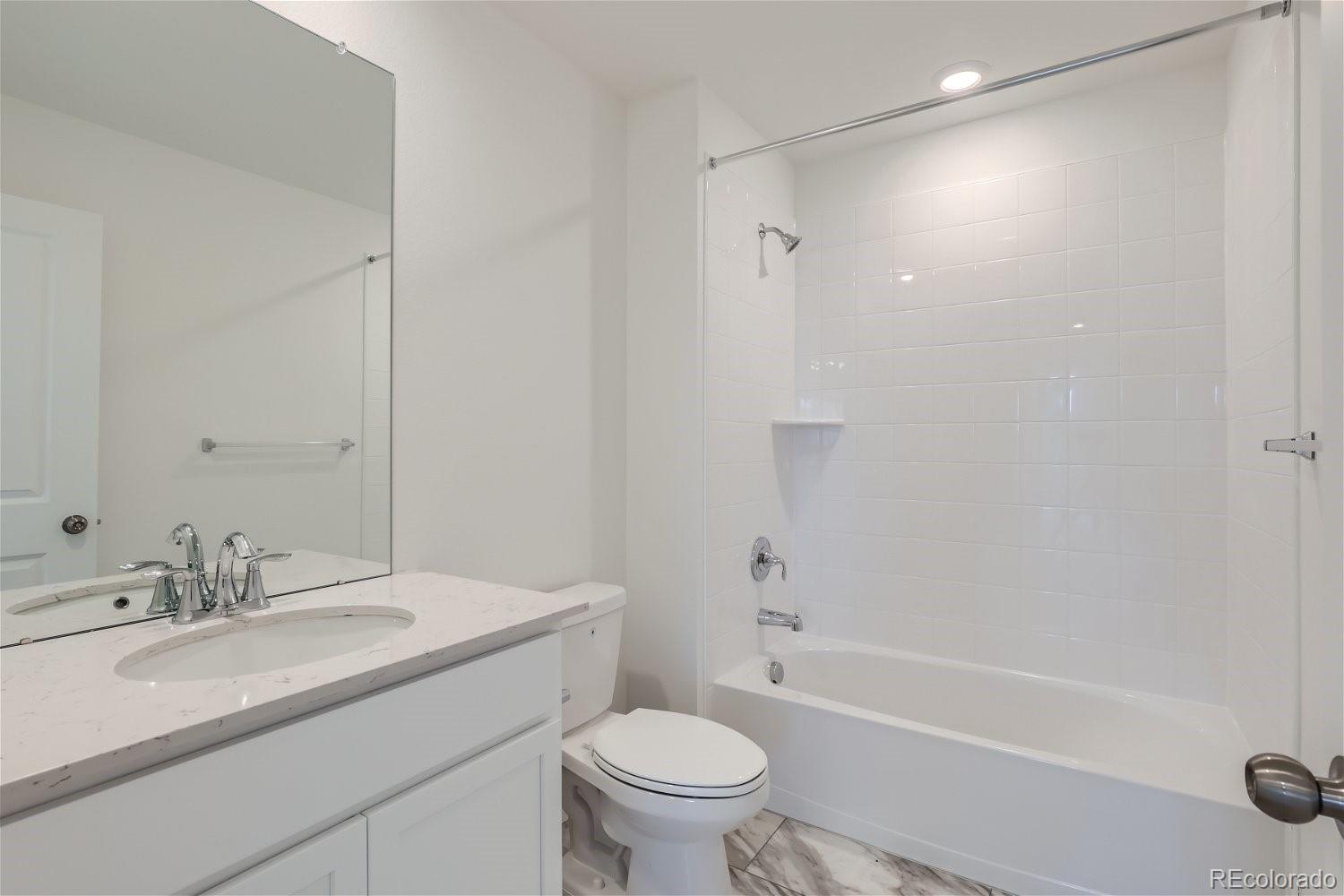 645 Yankee Boy Loop Elizabeth, CO 80107 - Photo 11 of 20 a bathroom with a granite countertop sink a toilet and a bathtub