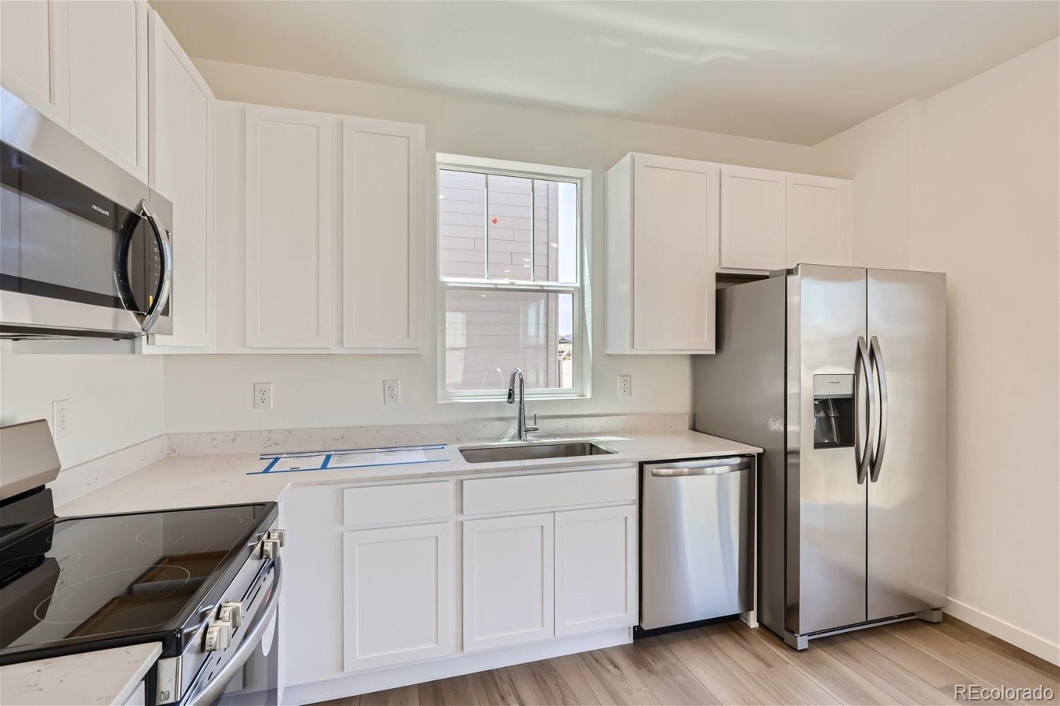 645 Yankee Boy Loop Elizabeth, CO 80107 - Photo 5 of 20 a kitchen with stainless steel appliances a sink stove and refrigerator