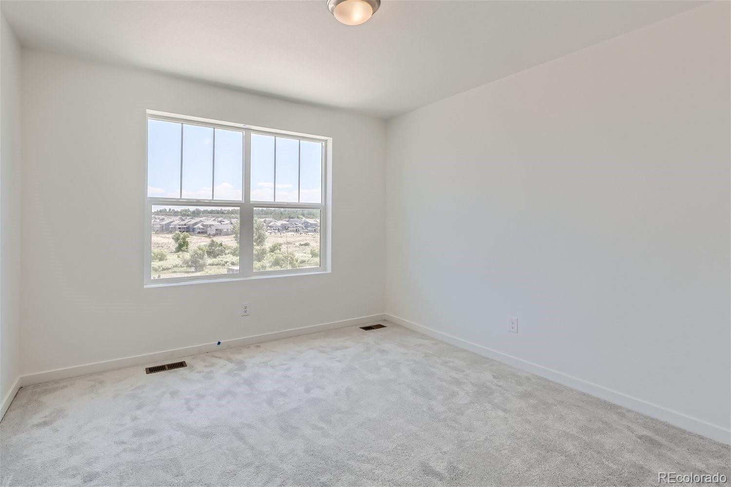 645 Yankee Boy Loop Elizabeth, CO 80107 - Photo 9 of 20 an empty room with a window