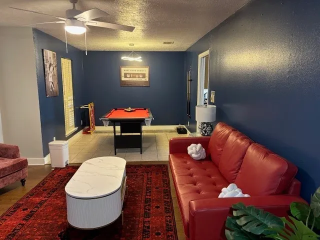 a living room with furniture a rug and a chandelier