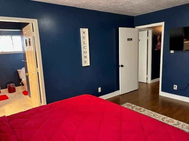 a bedroom with a bed and a dresser