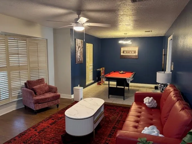 a living room with furniture a rug and a chandelier