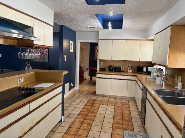 a kitchen with stainless steel appliances granite countertop a sink and cabinets