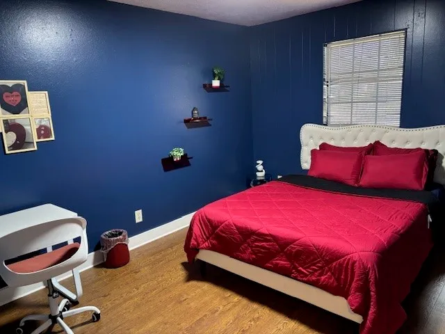 a bedroom with a bed and a window