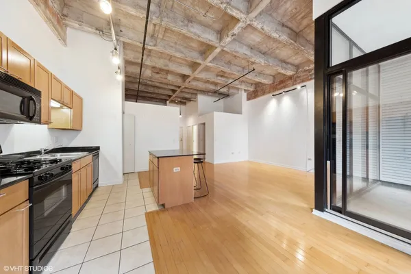 a kitchen with stainless steel appliances granite countertop a sink a stove top oven a counter space and cabinets