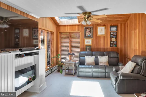 a bedroom with a bed wooden floor and window