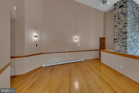 a view of room with window and wooden floor
