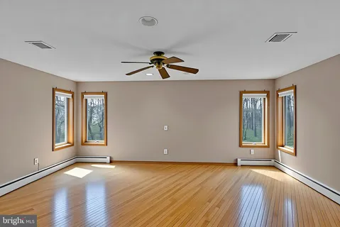 a bathroom with a granite countertop sink a stove and a refrigerator