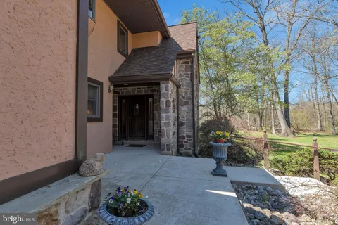 a view of a porch with furniture and a yard