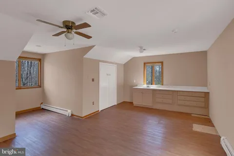 a view of a house with a big yard and large trees