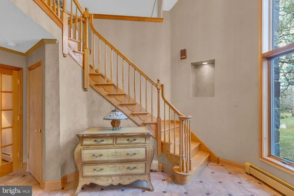 a view of entryway and hall with wooden floor