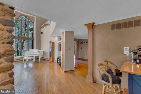 a kitchen with stainless steel appliances kitchen island granite countertop a table chairs and a refrigerator
