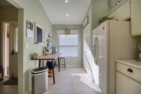 a kitchen with stainless steel appliances kitchen island granite countertop a refrigerator and cabinets