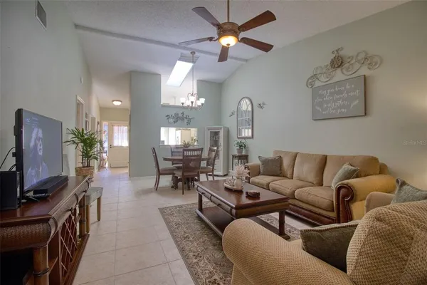 a dining room with furniture and chandelier