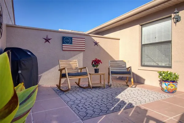 a backyard of a house with table and chairs