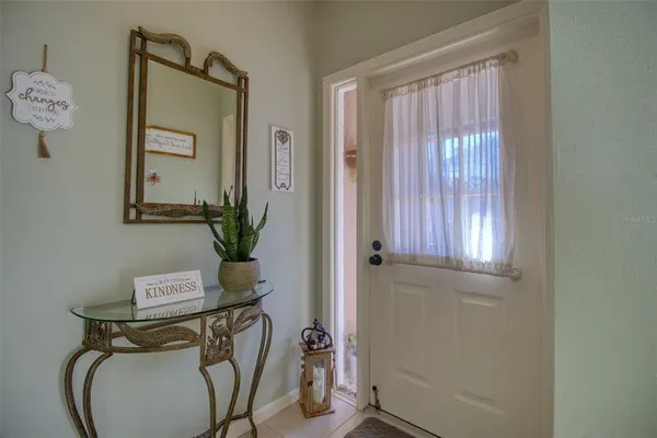 a view of front door with chair and wooden floor