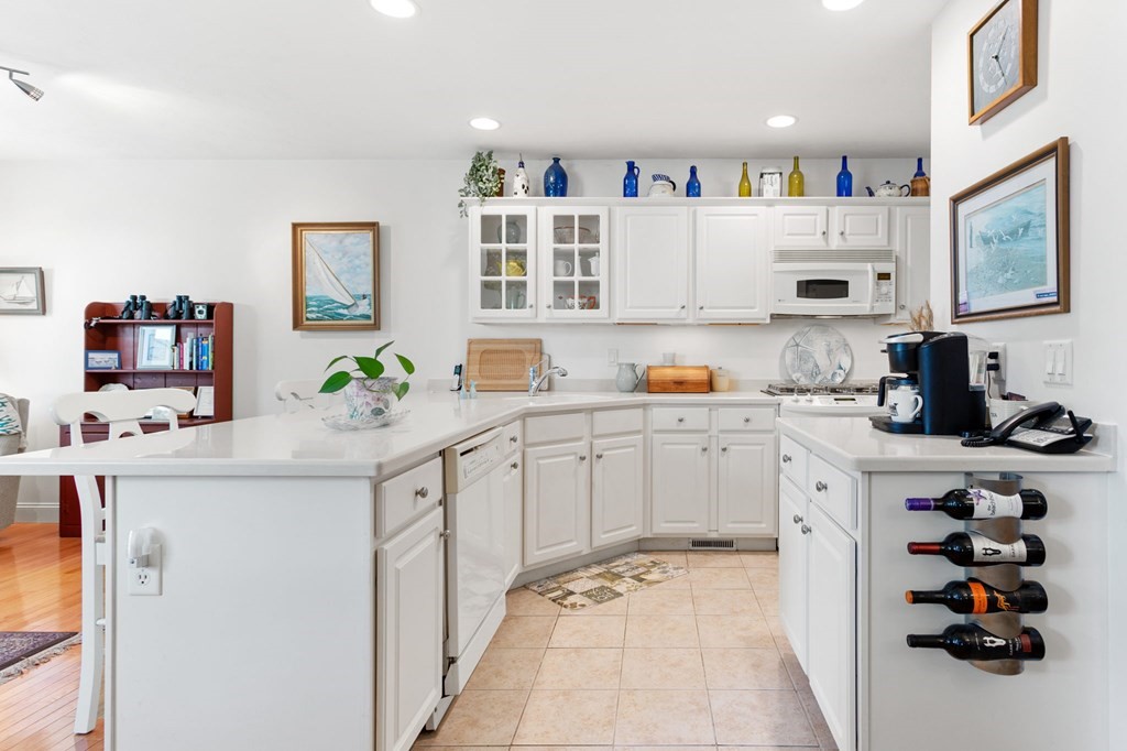 1 Prestwick Road, Unit 1 Bourne, MA 02532 - Photo 11 of 31 a kitchen with stainless steel appliances granite countertop a sink and a refrigerator
