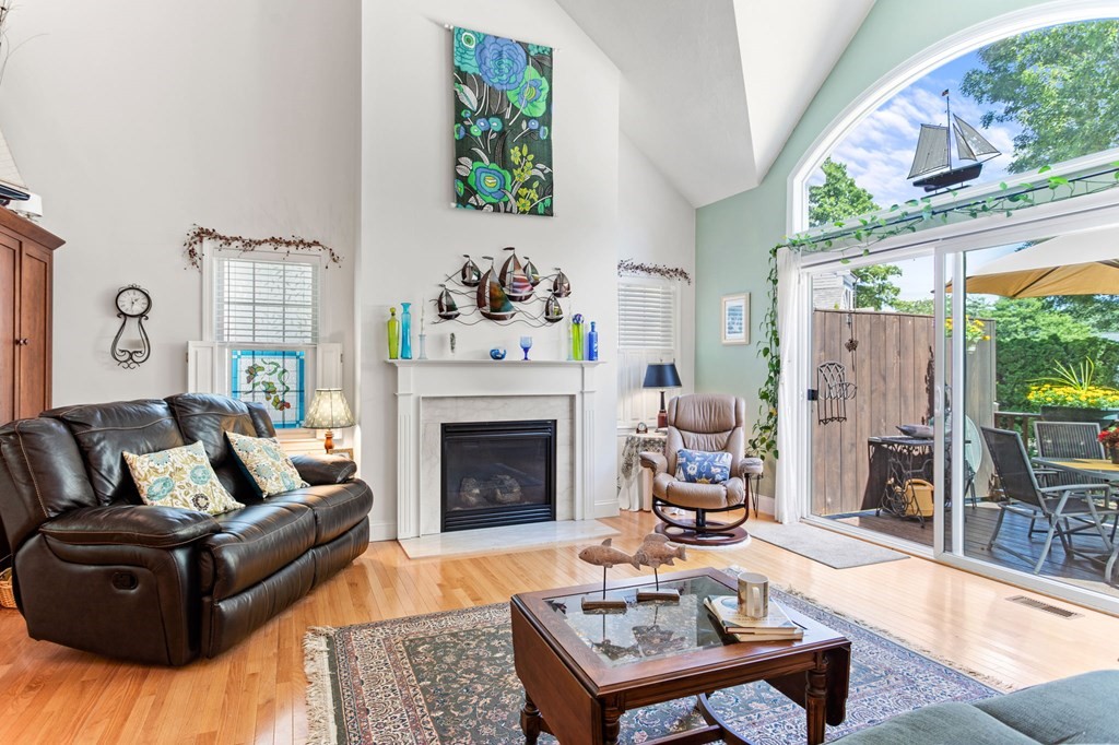 1 Prestwick Road, Unit 1 Bourne, MA 02532 - Photo 15 of 31 a living room with furniture fireplace and a large window