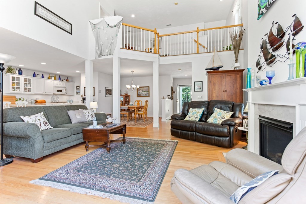 1 Prestwick Road, Unit 1 Bourne, MA 02532 - Photo 17 of 31 a living room with furniture and a fireplace