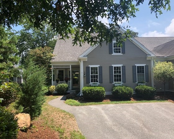1 Prestwick Road, Unit 1 Bourne, MA 02532 - Photo 2 of 31 a front view of a house with garden and trees