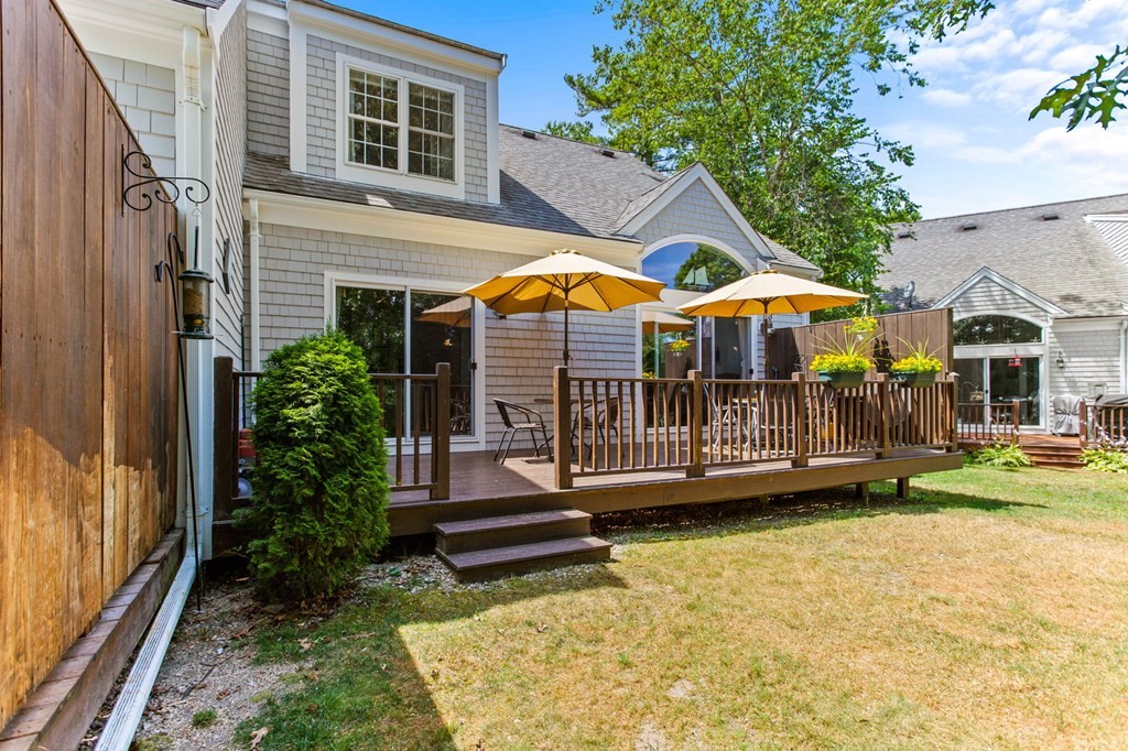 1 Prestwick Road, Unit 1 Bourne, MA 02532 - Photo 23 of 31 a view of a house with a yard porch and furniture